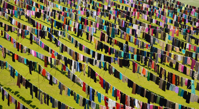 Dresses and skirts hang in lines in the football stadium of the city of Pristina in Kosovo.