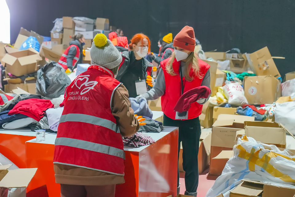 Female TOG volunteers coordinate operations at a storage unit in Hatay.