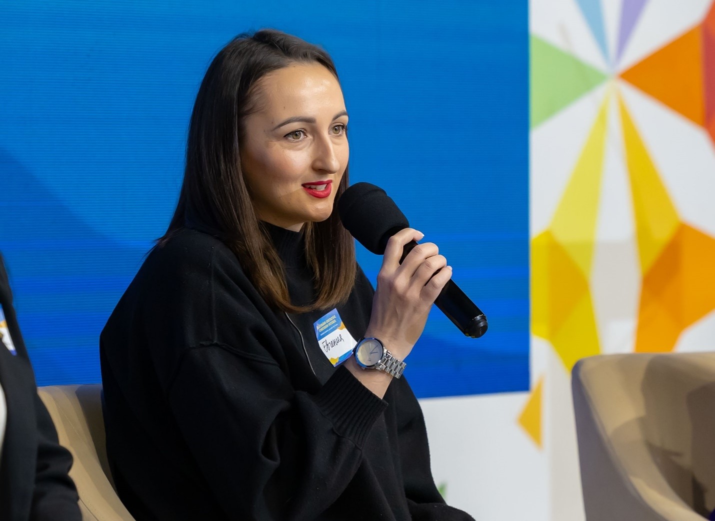 Evghenia Hutsuleac shares insights from her journey as a WoW programme beneficiary during the final event of the project "Strengthening the socioeconomic resilience of women and girls affected by the Ukrainian refugee crisis in Moldova." Photo credit: UN Women Moldova