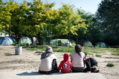 Two women sit with their children at Subotica Transit Centre in Serbia. Photo; UN Women/Ventura Formicone