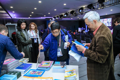 Participants of the panel session are getting the UN Women knowledge products. Photo: UN Women Kazakhstan/Batyr Aubakirov
