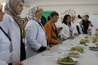 The delegates taste local pastries made by refugee and local women at the SADA Women-only Centre. Photo: Megumi Iizuka