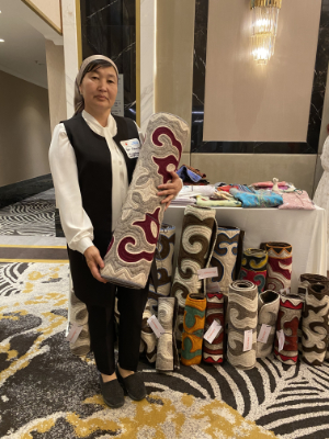 Nuriya Temirbek kyzy and felt products that she brought from Naryn region Central Kyrgyzstan. Photo: UN Women/Nargiz Koshoibekova