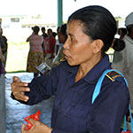 Timorese police officer speaking to community leader
