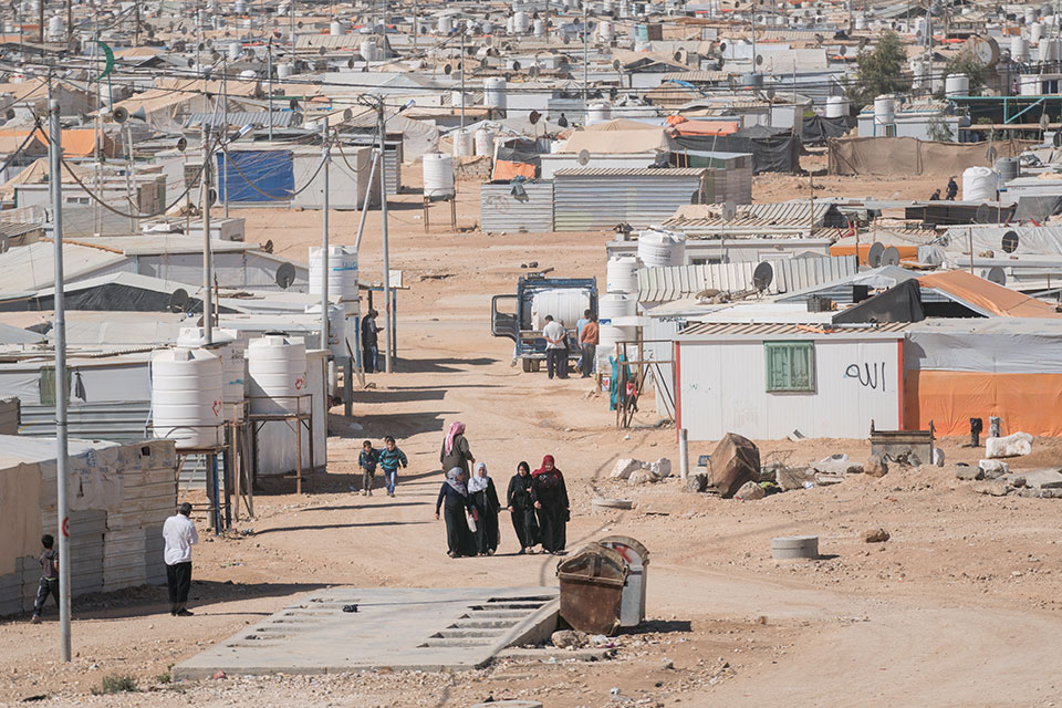 Women walk through the Zaatari Refugee camp in Jordan. 