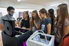 Girls interacting with a 3D printer. They have printed their first 3D designs. Photo: GirlsGoIT